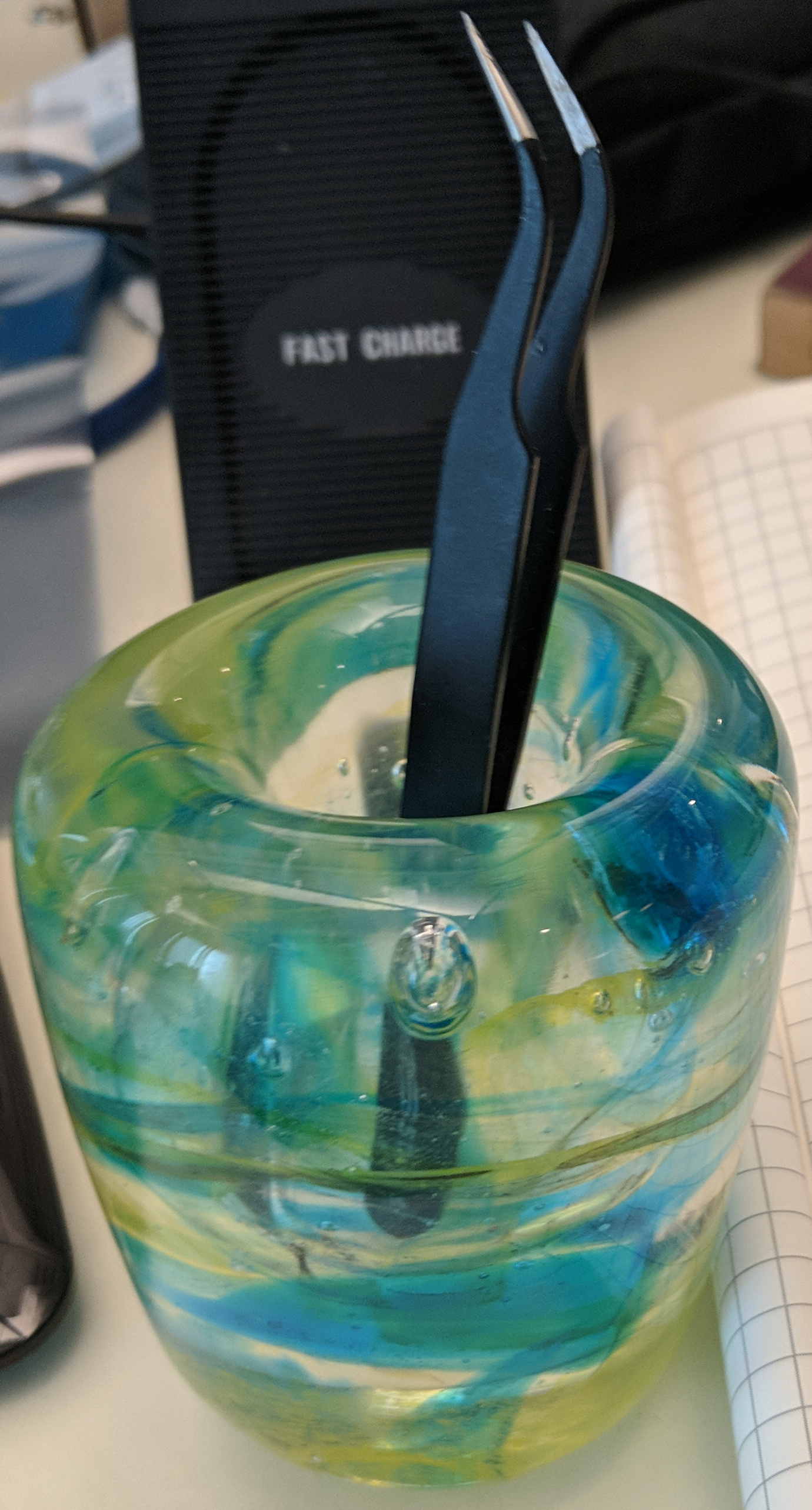 Holder thing with tweezers in it